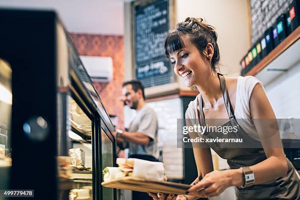 preparing the food display - koffiehuis stockfoto's en -beelden