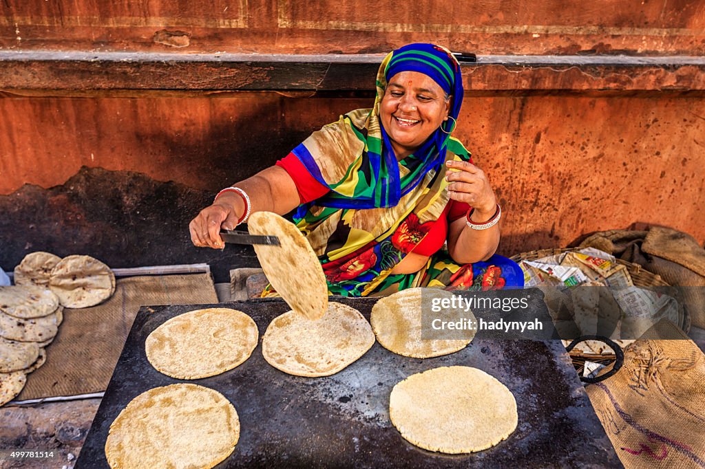 Indian street vendor preparing food - chapatti, flat bread