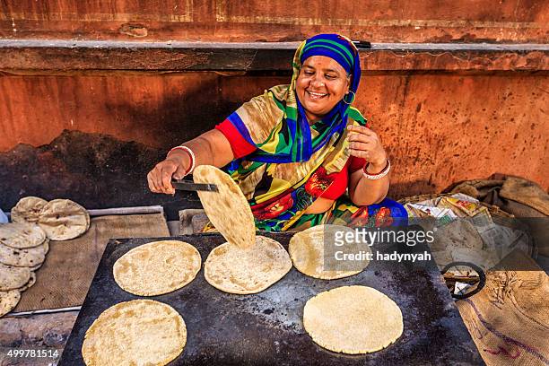 indian street vendor preparing food - chapatti, flat bread - rajasthani women stock pictures, royalty-free photos & images