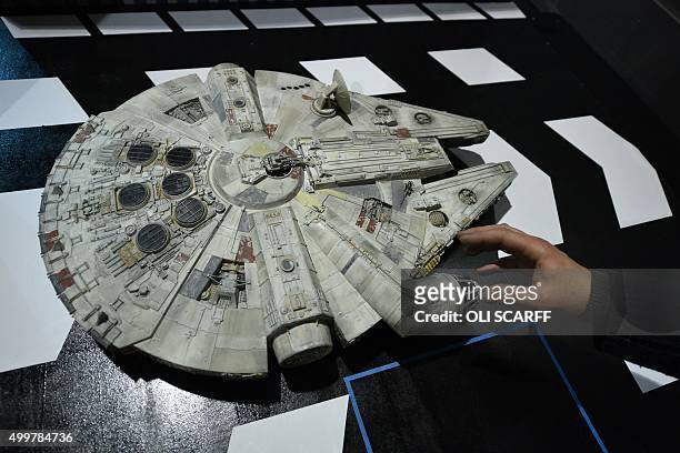 Star Wars enthusiast Andy Lee puts the finishing touches to a display of his model of the Millennium Falcon, which will feature in the unofficial...