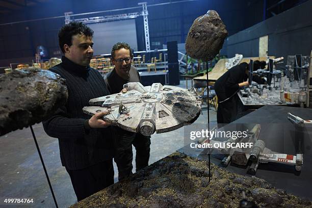 Star Wars enthusiast Andy Lee talks with a fellow enthusiast as he puts the finishing touches to a display of his model of the Millennium Falcon,...