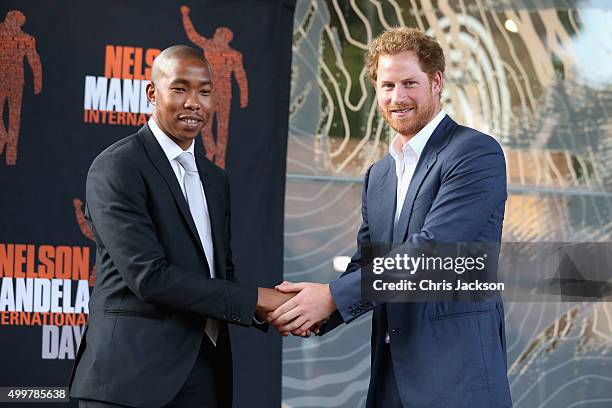 Prince Harry shakes the hand of Nelson Mandela's grandson, Mbuso Mandela at the Nelson Mandela Foundation Centre of Memory on December 3, 2015 in...