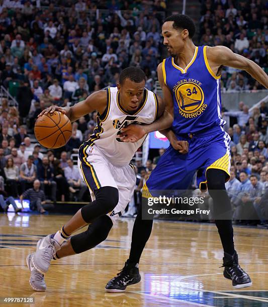 Guard Rodney Hood of the Utah Jazz drives to the basket on Golden State Warriors guard Shaun Livingston during the second half of an NBA game...