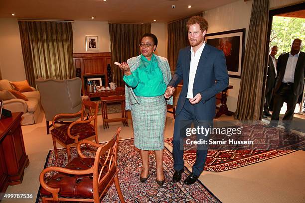 Prince Harry walks with Graca Machel, widow of Nelson Mandela, at the Nelson Mandela Foundation Centre of Memory during an official visit to Africa...