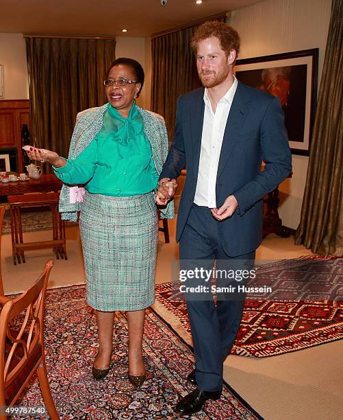 Prince Harry walks with Graca Machel, widow of Nelson Mandela, at the Nelson Mandela Foundation Centre of Memory during an official visit to Africa...