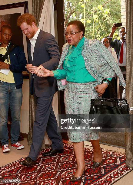 Prince Harry walks with Graca Machel, widow of Nelson Mandela, at the Nelson Mandela Foundation Centre of Memory during an official visit to Africa...