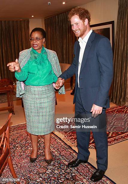 Prince Harry walks with Graca Machel, widow of Nelson Mandela, at the Nelson Mandela Foundation Centre of Memory during an official visit to Africa...