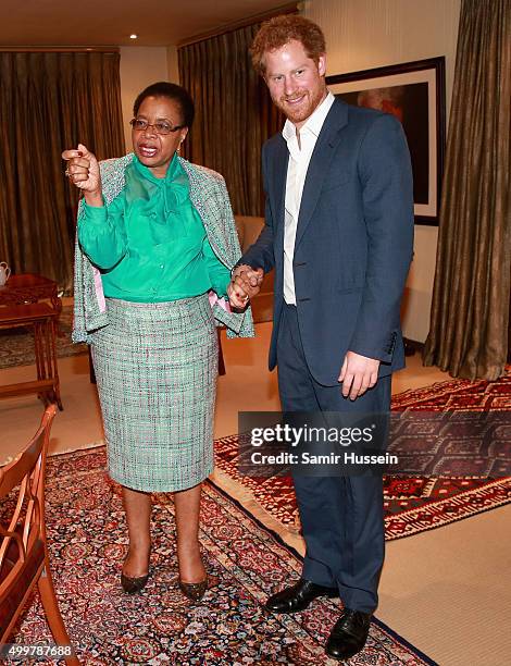 Prince Harry walks with Graca Machel, widow of Nelson Mandela, at the Nelson Mandela Foundation Centre of Memory during an official visit to Africa...