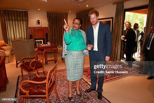 Prince Harry walks with Graca Machel, widow of Nelson Mandela, at the Nelson Mandela Foundation Centre of Memory during an official visit to Africa...