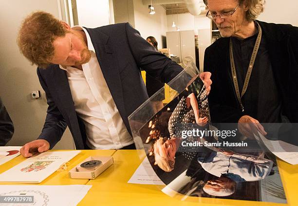 Prince Harry views an image of his late mother, Diana Princess of Wales and Nelson Mandela as he was given a tour of the private archives at the...