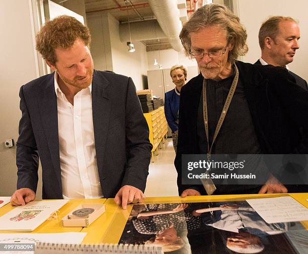 Prince Harry views an image of his late mother, Diana Princess of Wales and Nelson Mandela as he was given a tour of the private archives at the...