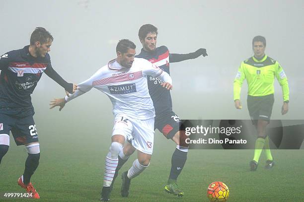 Marco Borriello of Carpi FC competes with Andrej Modic and Roberto Gagliardini of AC Vicenza during the TIM Cup match between Carpi FC and AC Vicenza...