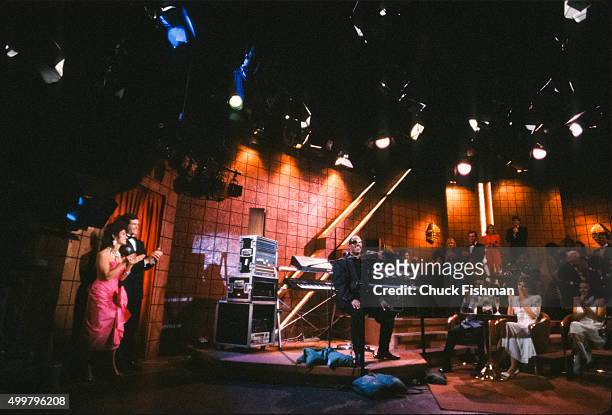 Cast members applaud American Jazz and Pop musician Stevie Wonder, who sits behind a piano, during a scene from an episode of the television soap...