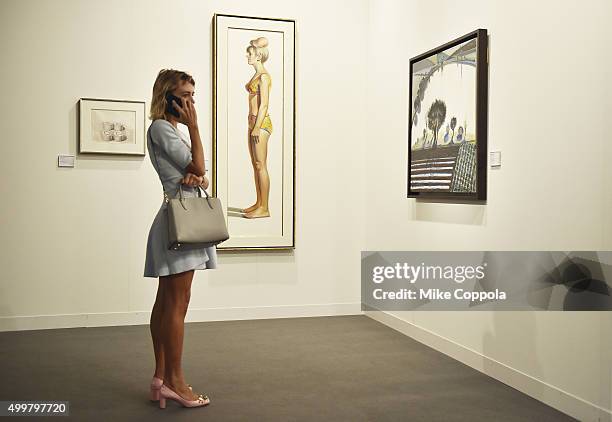 An attendee views 'Bikini Figure' by artist Wayne Thiebaud from Acquavella during Art Basel Miami Beach - Vernissage at the Miami Beach Convention...