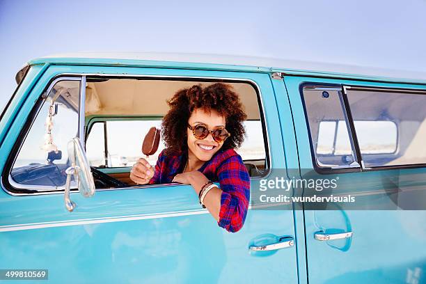 hipster girl with icecream in camper van - minivan stockfoto's en -beelden