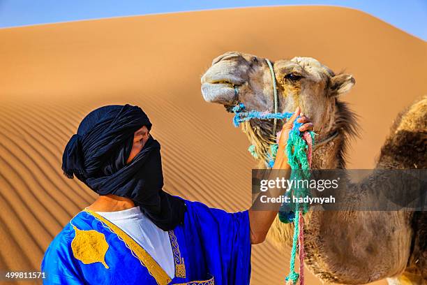 young tuareg with camel on western sahara desert in africa - merzouga stock pictures, royalty-free photos & images