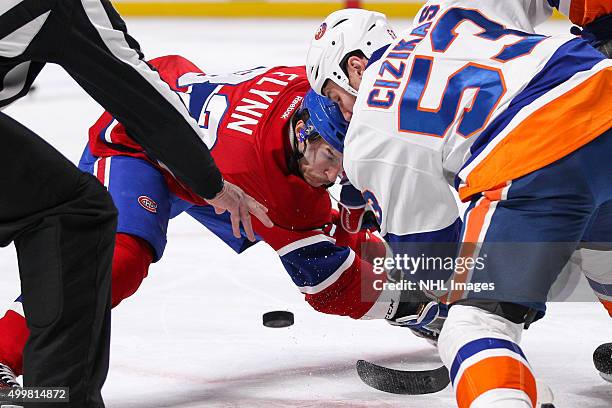 Brian Flynn of the Montreal Canadiens and Casey Cizikas of the New York Islanders face-off in the NHL game at the Bell Centre on November 22, 2015 in...