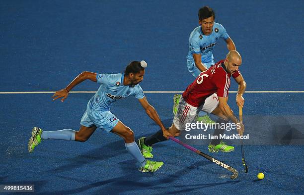 Nick Catlin of Great Britain runs with the ball during the match between India and Great Britain on day seven of The Hero Hockey League World Final...