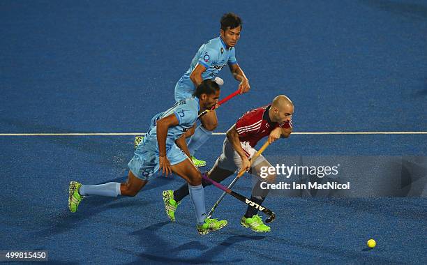 Nick Catlin of Great Britain runs with the ball during the match between India and Great Britain on day seven of The Hero Hockey League World Final...
