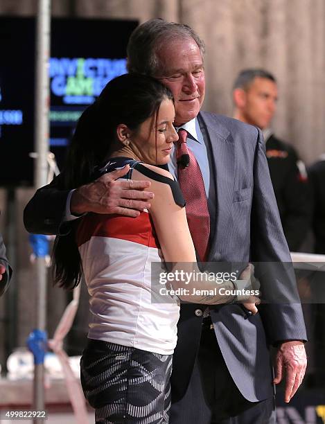 Yeoman 3rd Class Kristen Esget hugs Former President George W. Bush during an event to announce a major initiative prior to the 2016 Invictus Games...