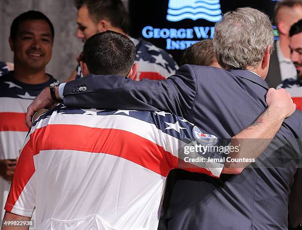 Staff Sergeant Nicholas Dadgostar hugs Former President George W. Bush during an event to announce a major initiative prior to the 2016 Invictus...