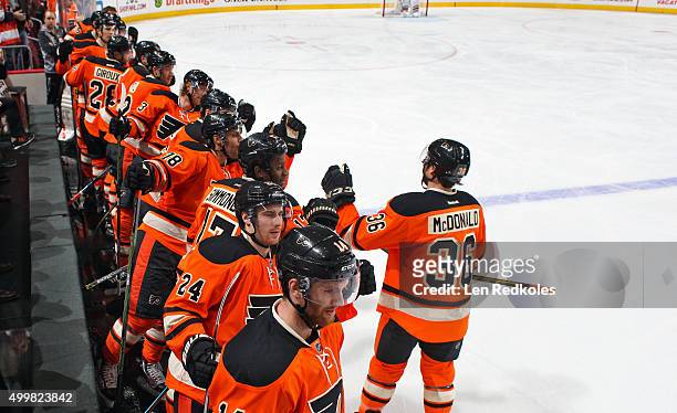 Colin McDonald of the Philadelphia Flyers celebrates his third period goal with teammates on the bench against the Nashville Predators on November...