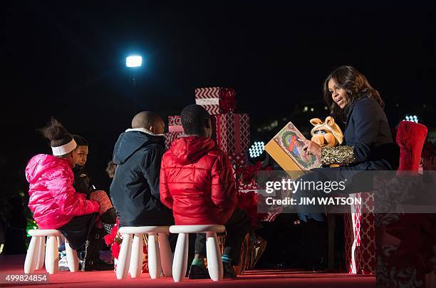 First Lady Michelle Obama and Muppet Miss Piggy read "Twas the Night Before Christmas" to children after lighting the National Christmas Tree in...