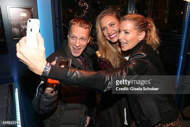 Oliver Pocher, Alena Gerber and Giulia Siegel take a selfie at the opening party of the Johnnie Walker Blue Label Pop-Up area at Brenner on December...