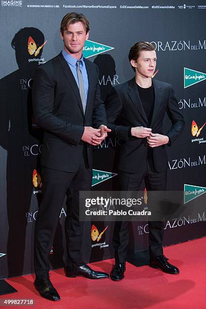 Chris Hemwsworth and Tom Holland attend the 'En el Corazon del Mar' premiere at Callao City Lights Cinema on December 3, 2015 in Madrid, Spain.