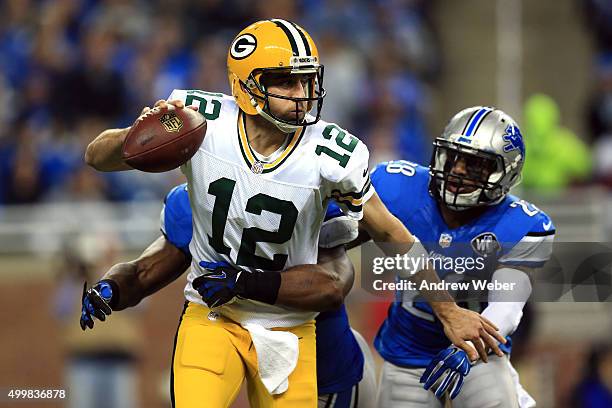 Quarterback Aaron Rodgers of the Green Bay Packers is sacked by middle linebacker Stephen Tulloch and cornerback Quandre Diggs of the Detroit Lions...