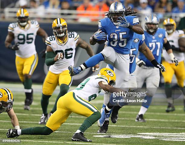 Joique Bell of the Detroit Lions jumps over Casey Hayward of the Green Bay Packers in the second half on December 3 2015 at Ford Field in Detroit,...