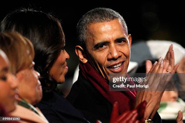 President Barack Obama shares a laugh with First Lady Michelle Obama during the 93rd Annual National Christmas Tree Lighting at The Ellipse on...