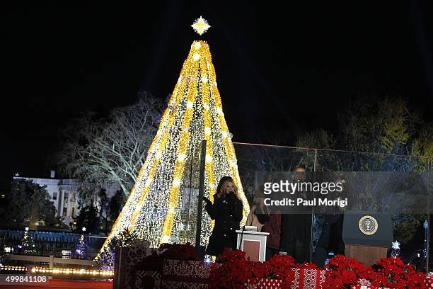 President Barack Obama and First Lady Michelle Obama light the National Christmas Tree with Reese Witherspoon and Malia Ann Obama during the 93rd...