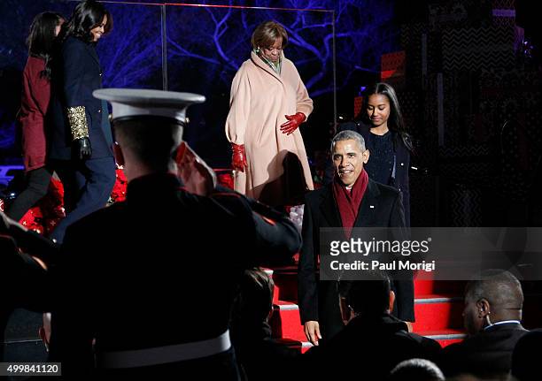 President Barack Obama is saluted by a soldier as he and the First family arrive to the 93rd Annual National Christmas Tree Lighting at The Ellipse...