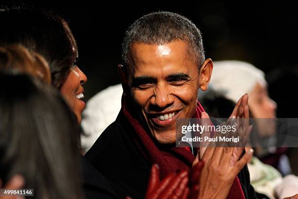 President Barack Obama shares a laugh with First Lady Michelle Obama during the 93rd Annual National Christmas Tree Lighting at The Ellipse on...