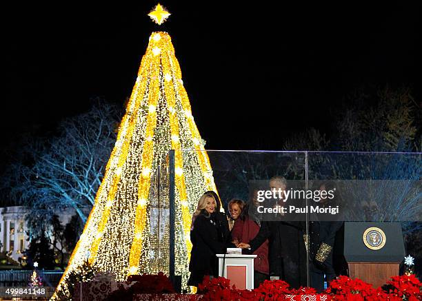 President Barack Obama and First Lady Michelle Obama light the National Christmas Tree with Reese Witherspoon and Malia Ann Obama during the 93rd...