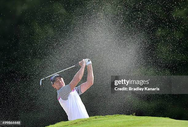 Brett Rumford of Australia plays a shot out of the bunker on the 18th hole during day two of the 2015 Australian PGA Championship at Royal Pines...