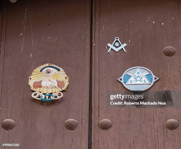 Trinidad de Cuba scenes: Freemasonry, FLT insignia on old wooden door in Trinidad, Cuba. The Square and Compass Freemason symbol along with vintage...