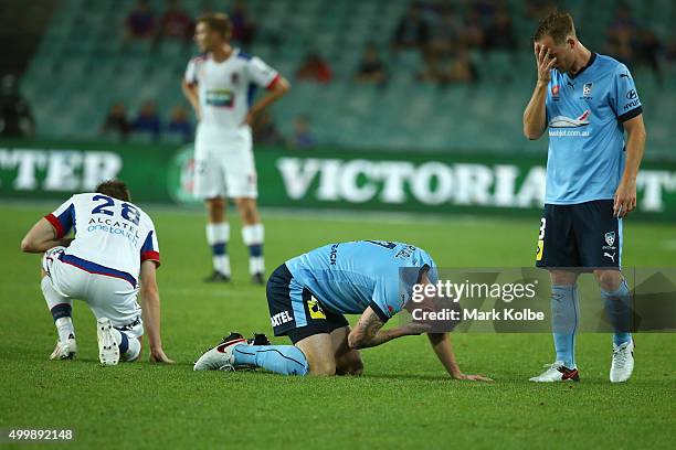 Ryan Kitto of the Jets and Seb Ryall and Rhyan Grant of Sydney FC are seen after a heavy clash during the round nine A-League match between Sydney FC...