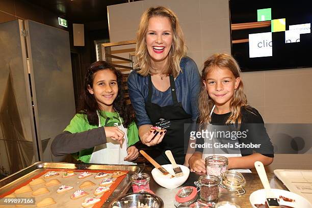 Monica Ivancan prepares cookies with children during the World Childhood Foundation Baking at Hotel Vier Jahreszeiten on November 30, 2015 in Munich,...