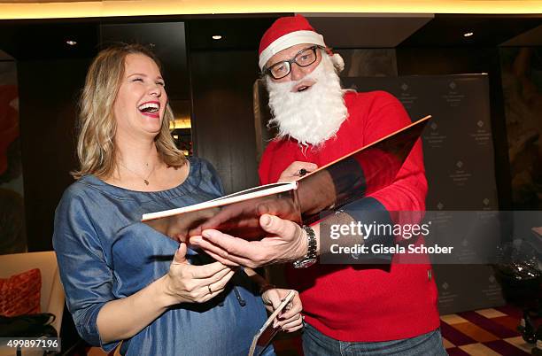 Monica Ivancan and Michael Hartl as Santa Claus during the World Childhood Foundation Baking at Hotel Vier Jahreszeiten on November 30, 2015 in...