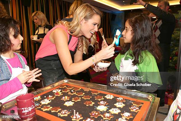 Vanessa Meisinger prepares cookies with children during the World Childhood Foundation Baking at Hotel Vier Jahreszeiten on November 30, 2015 in...