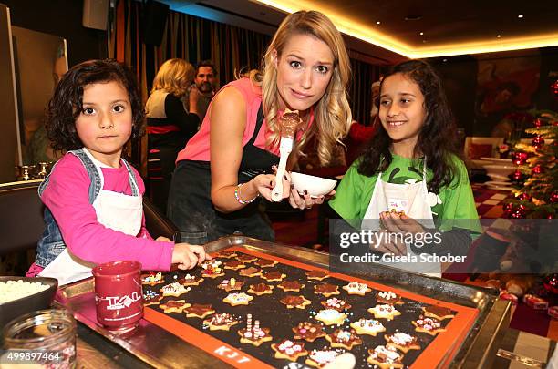 Vanessa Meisinger prepares cookies with children during the World Childhood Foundation Baking at Hotel Vier Jahreszeiten on November 30, 2015 in...