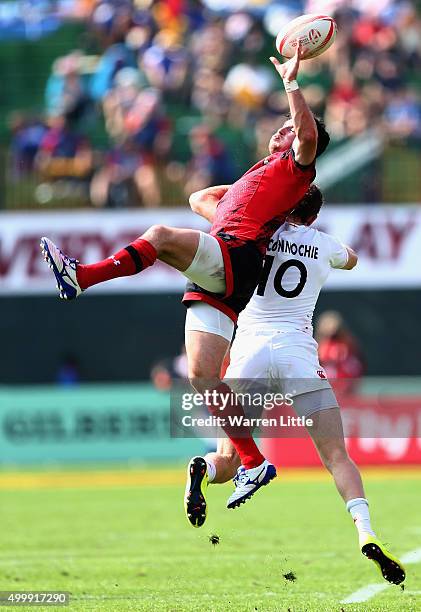 Owen Jenkins of Wales jumps for the ball against Ruaridh McConnochie of England during the Emirates Dubai Rugby Sevens - HSBC Sevens World Series at...