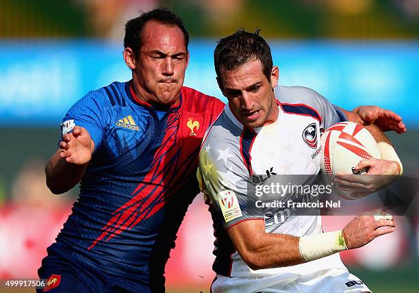 Zack Test of the USA is tackled by Damien Cler of France during the Emirates Dubai Rugby Sevens - HSBC World Rugby Sevens Series on December 4, 2015...