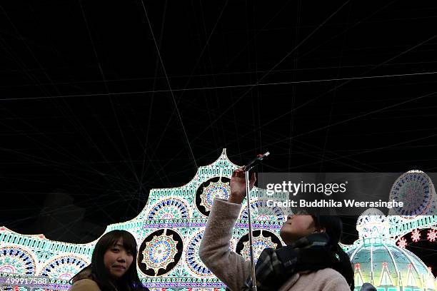 Woman take a selfie under an illuminated structure as a part of the 21th Kobe Luminarie on December 4, 2015 in Kobe, Japan. This annual event,...