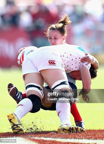 Marina Kukina of Russia is tackled by Emily Scarratt of England during the Emirates Dubai Rugby Sevens - HSBC World Rugby Women's Sevens Series at...