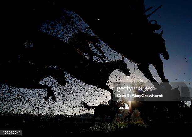 General view as runners clear the open ditch in front of the grandstands at Sandown racecourse on December 04, 2015 in Esher, England.