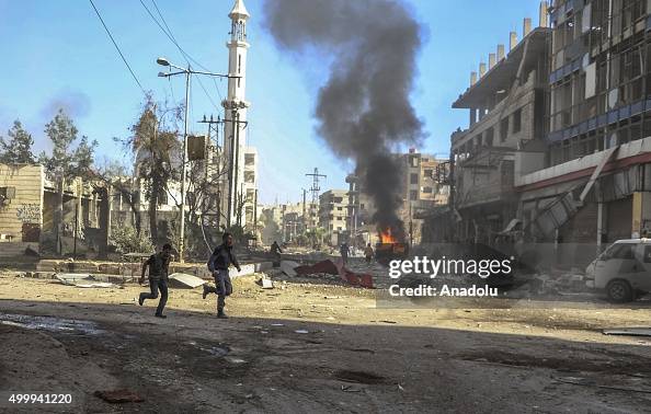 Syria The Fire Rises Smoke rises as Syrians run away from a fire which broke out after the ...
