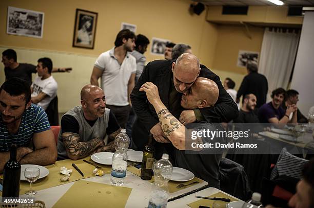 Former player of Santo Spirito Bianchi Team, Alessandro Giustini , hugs his team-mate Maurizio Bonfiglio during a dinner after a training session on...